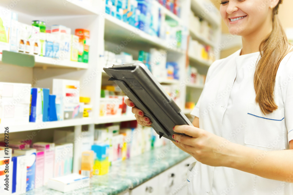 Pharmacist working with a tablet computer in the pharmacy