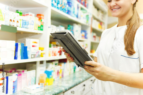 Pharmacist working with a tablet computer in the pharmacy Free Download Pharmacist working with a tablet computer in the pharmacy - GFXLoad