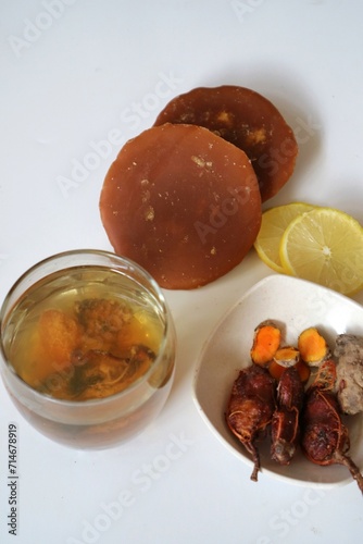 Asam jawa and kunyit or tamarind drink. Ussually used to make indonesian traditional herbal drink for women. jamu kunyit asam with the basic ingredients of turmeric and tamarind and other herbs.  photo