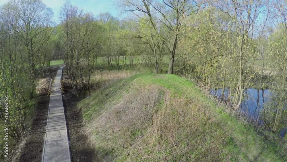 Footpath and wooden bridge over Yauza river in national park