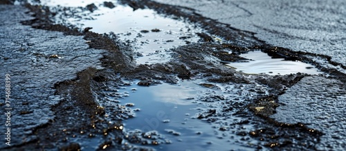 Oil spills contaminate wet asphalt, highlighting environmental pollution.