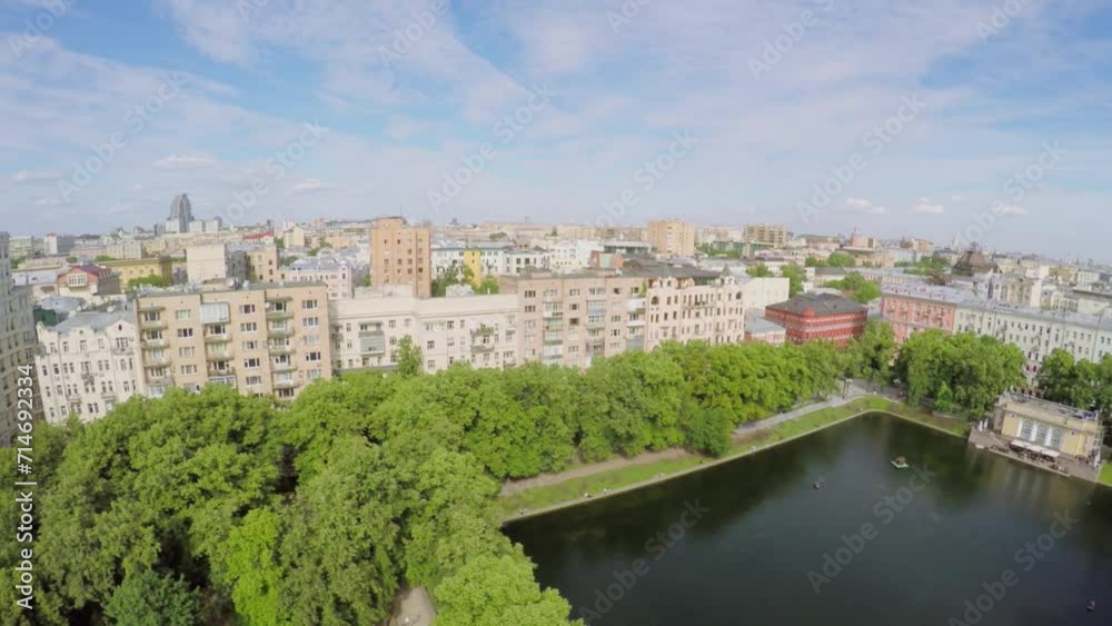 City panorama with residential houses around park with pond City panorama with residential houses around park with pond