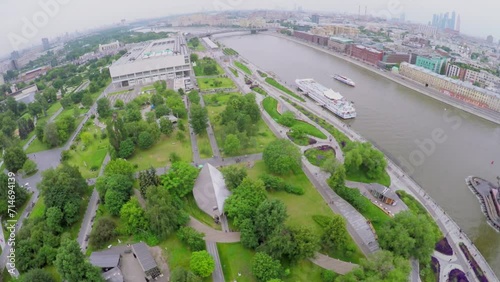 Park on quay not far from statue of Peter The Great and skyscrapers