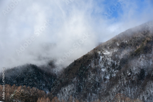雨上がりの雲に覆われる雪山と青空 © FURISHO