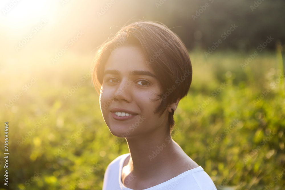 Portrait of cute brunette teen girl walking at meadow field Portrait of cute brunette teen girl walking at meadow field