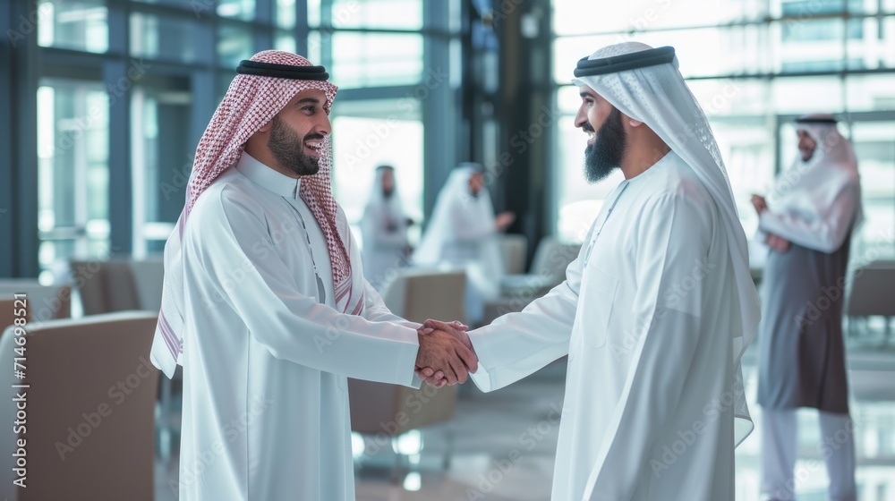 Middle Eastern Business Partners Striking a Successful Deal at a Corporate Modern Meeting Room. Two Arab Men Shaking Hands, Managers in Traditional White Robes Celebrating and Clapping Hands