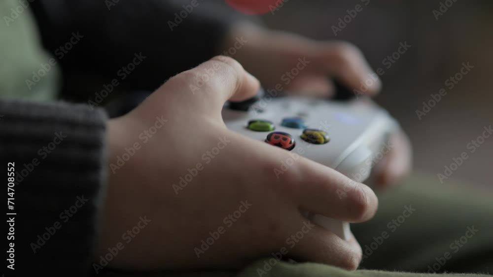 Close up of Teenage Gamer Hands Playing Video Game on Console Using Joystick. Child Playing on Black Controller in Computer Video Game. Hands Person Playing Video Games on Console With Gamepad at Home Close up of Teenage Gamer Hands Playing Video Game on Console Using Joystick. Child Playing on Black Controller in Computer Video Game. Hands Person Playing Video Games on Console With Gamepad at Home