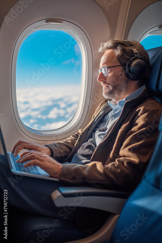 businessman plane with laptop, Korean trader financier works at computer in airplane