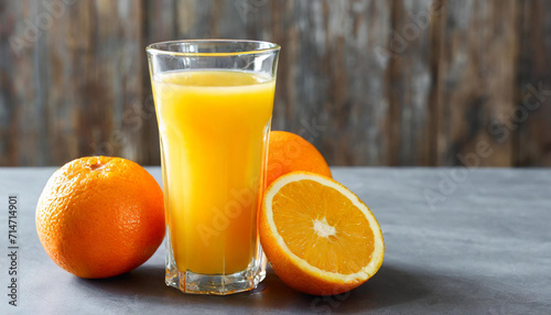 Delicious orange juice and fresh fruit on grey table  space for text