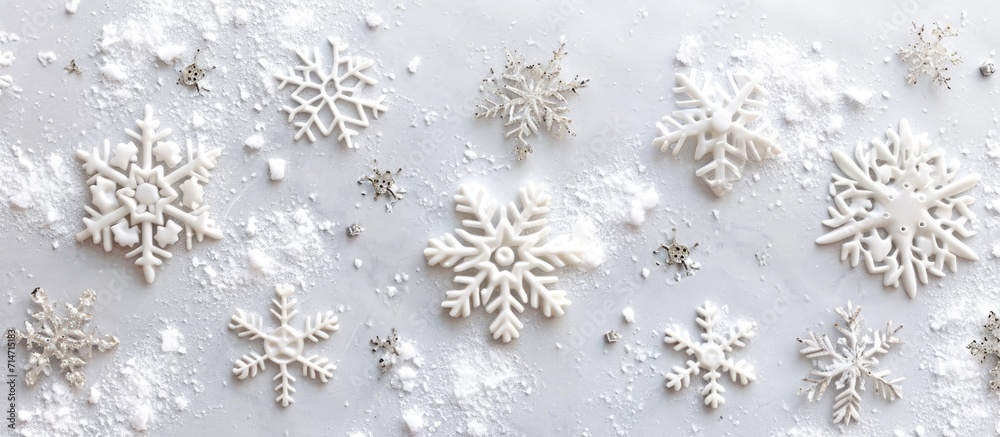 Snowflakes and snow on a pastel gray background, symbolizing Christmas. Winter theme, flat lay, top view, with room for text. Snowflakes and snow on a pastel gray background, symbolizing Christmas. Winter theme, flat lay, top view, with room for text.