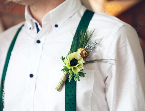 Groom wearing buttonhole with white anemone photo