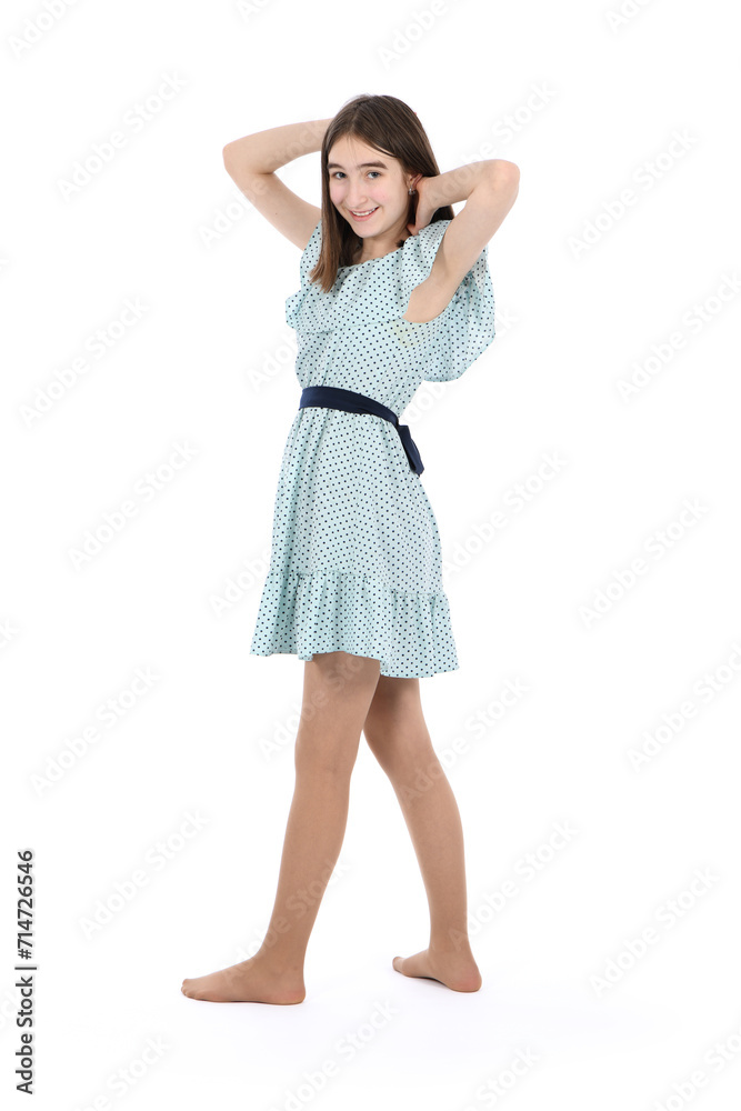 Young beautiful girl in a dress with polka dots on a white background. Young beautiful girl in a dress with polka dots on a white background.