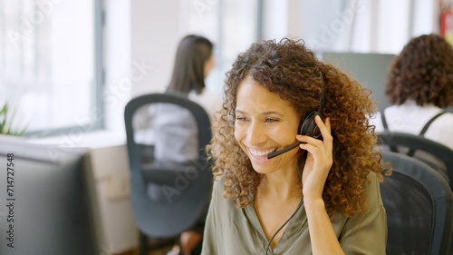 Telephone operator answering with a smile in a coworking space photo