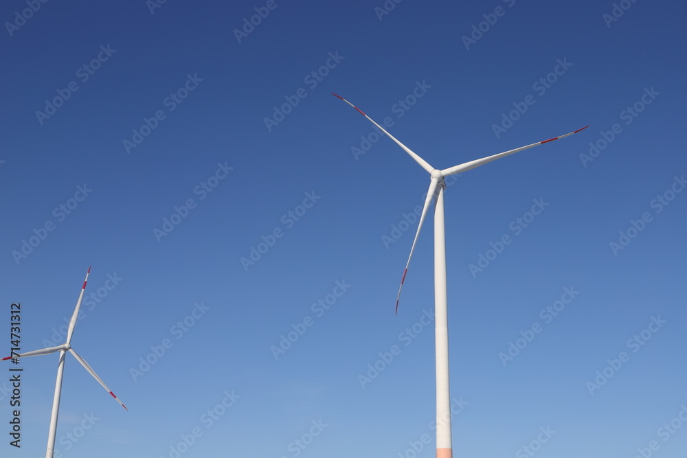 Wind turbine on a field with blue sky