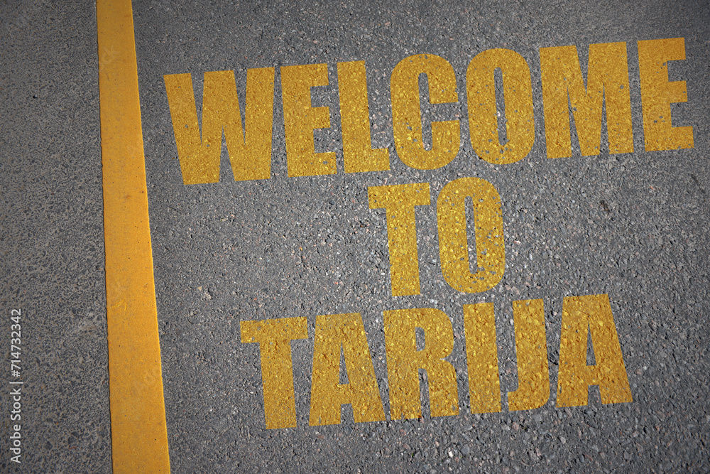 asphalt road with text welcome to Tarija near yellow line.