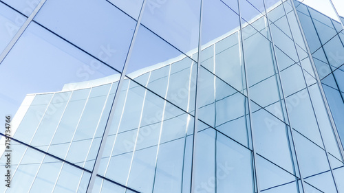 Architecture of the facade of the building made of glass panels with reflections