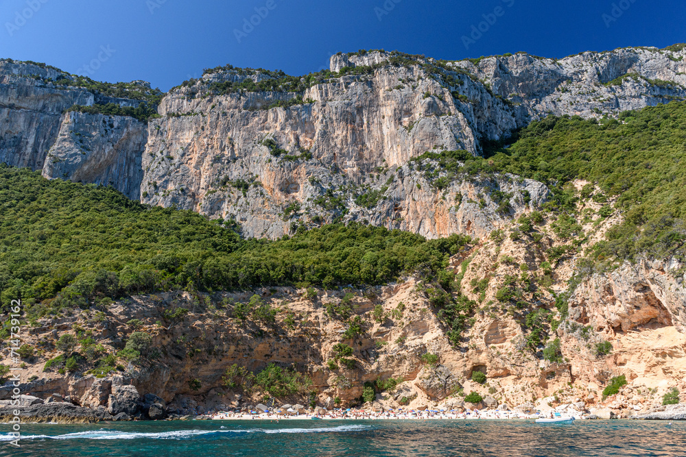 The cliffed coast of the Orosei gulf and the bay Cala Biriala in east Sardinia seen from the sea