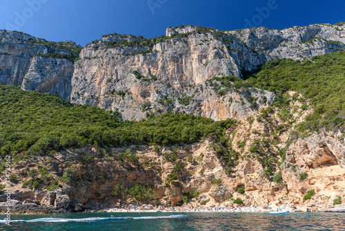 The cliffed coast of the Orosei gulf and the bay Cala Biriala in east Sardinia seen from the sea