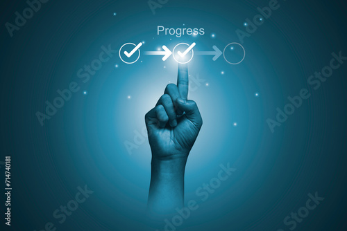 Hand touching to tick correct mark in checklist with progressive loading status to remind work task progressive for project develop management and tracking concept.