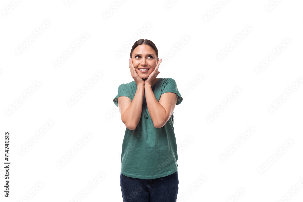 well-groomed slim young brunette woman dressed in a green t-shirt smiling on a white background with copy space well-groomed slim young brunette woman dressed in a green t-shirt smiling on a white background with copy space