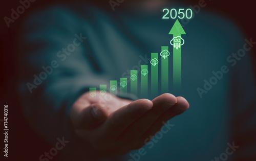 ฺีBusinessman holding reduction carbon emission on increasing graph for carbon footprint and carbon credit to limit global warming from climate change in Kyoto protocol within 2050 concept. photo