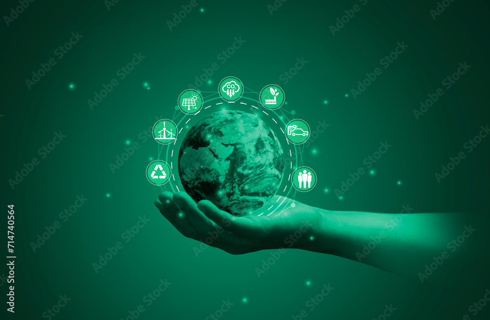 Businessman holding world map with environment icon such as carbon reduction green factory recycle and solar cell for zero carbon emission credit to prevent global warming, World Element from NASA.