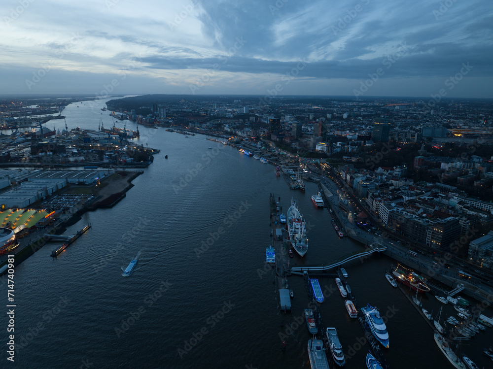 Skyline of Hamburg at dusk, the River Elbe and the large commercial industrial port. City view.