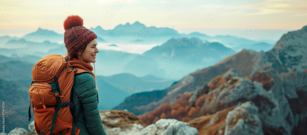Mountain Trail Joy. Smiling woman with backpack hiking in mountains. - obrazy, fototapety, plakaty 