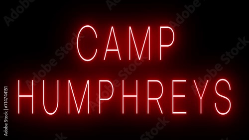 Flickering red retro style neon sign glowing against a black background for CAMP HUMPHREYS photo