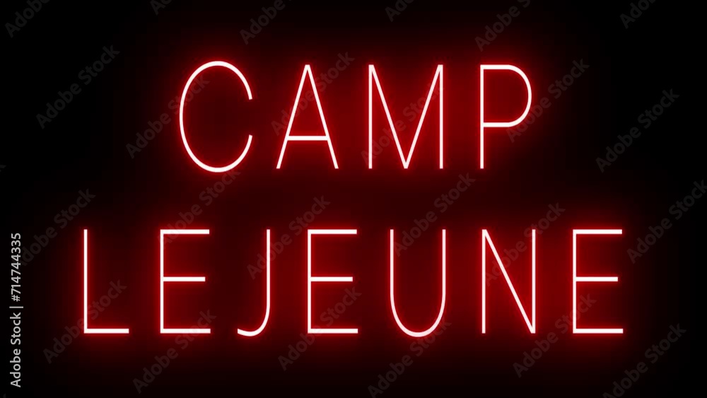 Flickering red retro style neon sign glowing against a black background for CAMP LEJEUNE