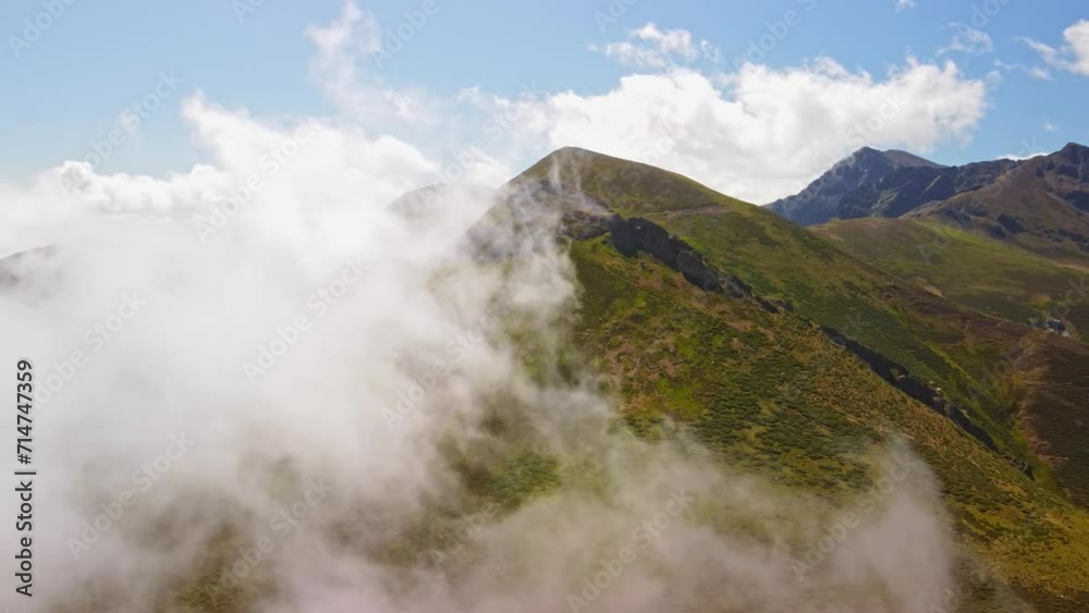 A majestic mountain range engulfed in clouds A majestic mountain range engulfed in clouds