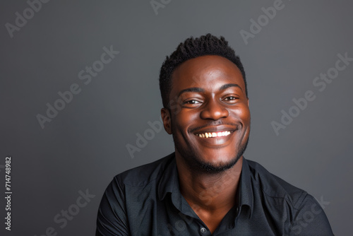 A man in a black shirt is smiling for the camera