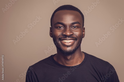 A man in a black shirt smiles for the camera