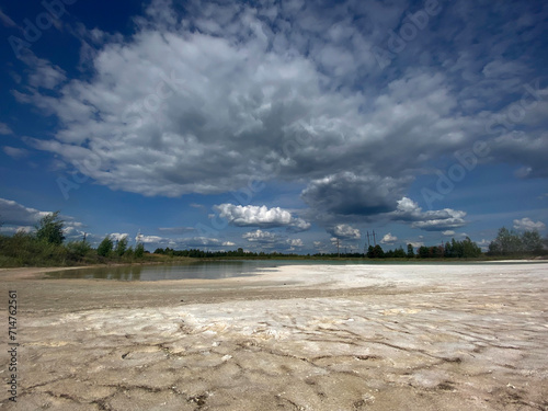 A dried-up lake with cracked parched earth due to drought in summer day
