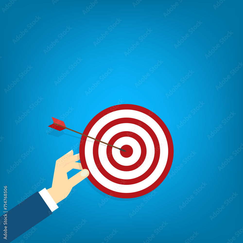 Hand holding a target, showing a goal. Red arrow hits the center. Business challenge failure and success concept. Hand holding a target, showing a goal. Red arrow hits the center. Business challenge failure and success concept.