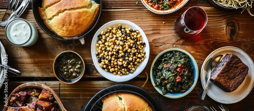 Bird's eye view of traditional Southern meal with black-eye peas, collard greens and cornbread photo