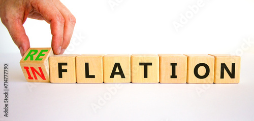 Reflation or inflation symbol. Concept word Reflation Inflation on beautiful wooden cubes. Beautiful white table white background. Businessman hand. Business reflation or inflation concept. Copy space photo