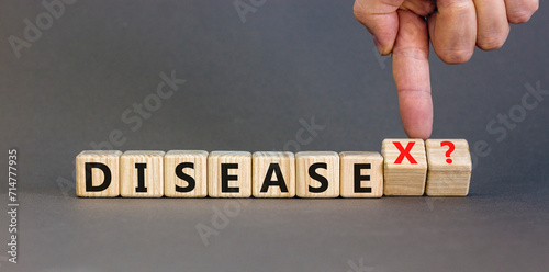 Disease X after covid symbol. Turned cubes and changed the word Disease to Disease X. Beautiful grey table grey background. Doctor hand. Medical, Disease X after covid concept. Copy space. photo