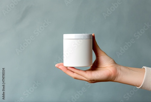 Mockup of female hands elegantly holding a jar of cosmetic cream, presenting a branding opportunity for cosmetic beauty products.