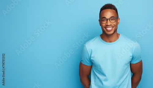 African american man waring blue t-shirt and glasses isolated on blue background photo