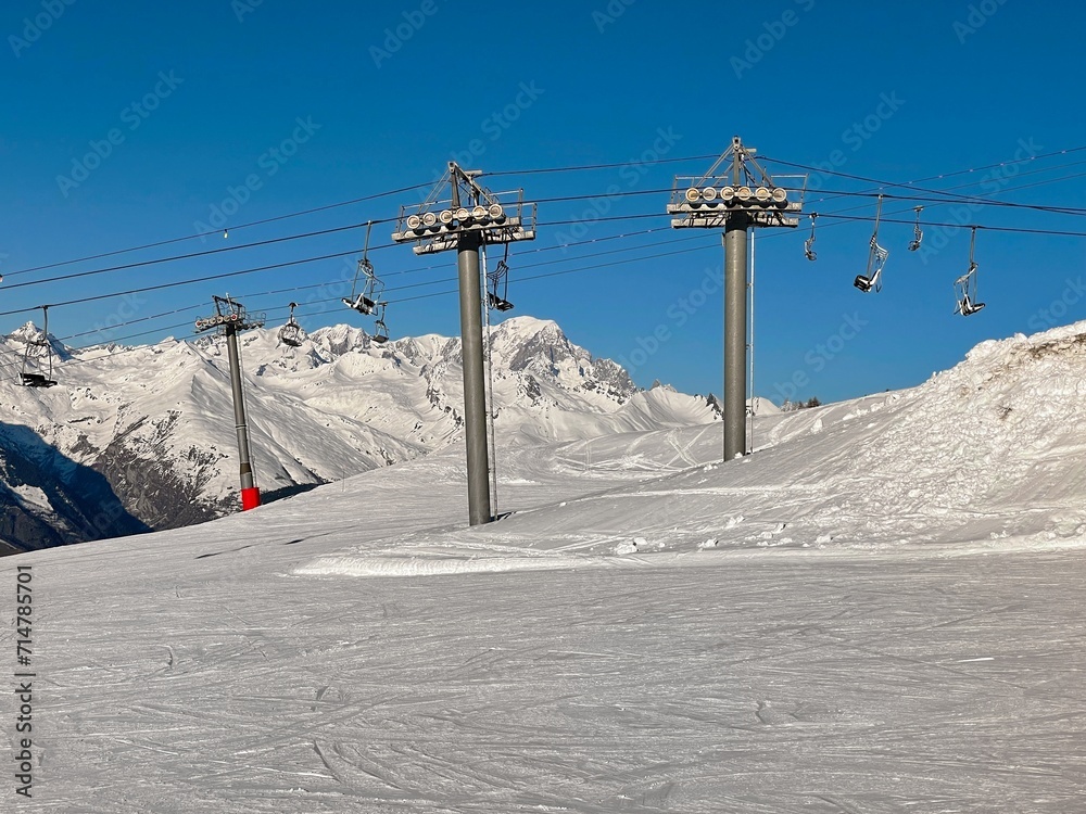 Fototapeta premium ski lift in beautiful snowy mountains in a ski resort in Tarentaise france