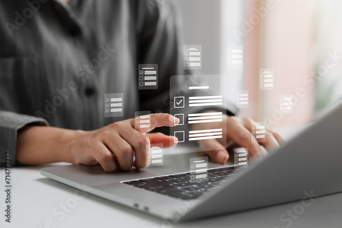 Business performance monitoring concept, businesswoman using laptop Online survey filling out, digital form checklist. photo