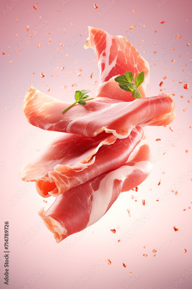 Delicate slices of prosciutto with fresh parsley leaves tumble gently, displayed on a sofy pink background. 
 - obrazy, fototapety, plakaty 