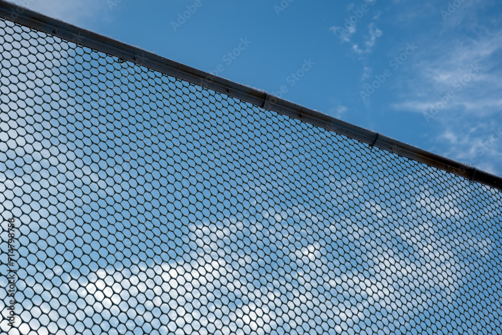 Metal fence on a blue sky background Metal fence on a blue sky background