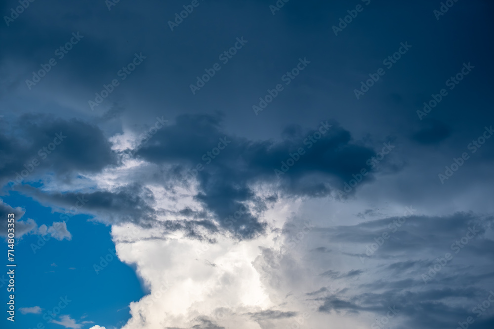 White clouds and dark clouds against the sky.