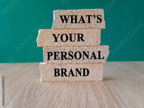 What's your personal brand symbol. Concept words What's your personal brand on brick blocks. Beautiful wooden table, green background. Business what is your personal brand concept.