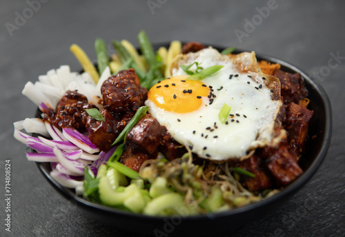 bibimap bowl with tofu, egg, celery, kimchi and black sesame photo