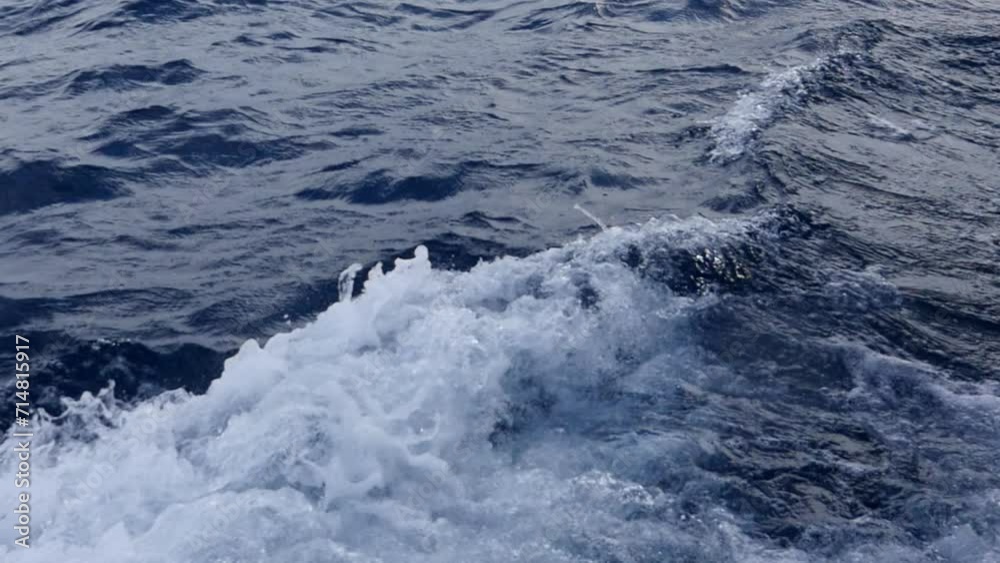 Waves of water, board of white yacht, movement. Waves of water arising from movement of yacht. Background for contemplation with clean clear water of ocean. Waves of water, board of white yacht, movement. Waves of water arising from movement of yacht. Background for contemplation with clean clear water of ocean.