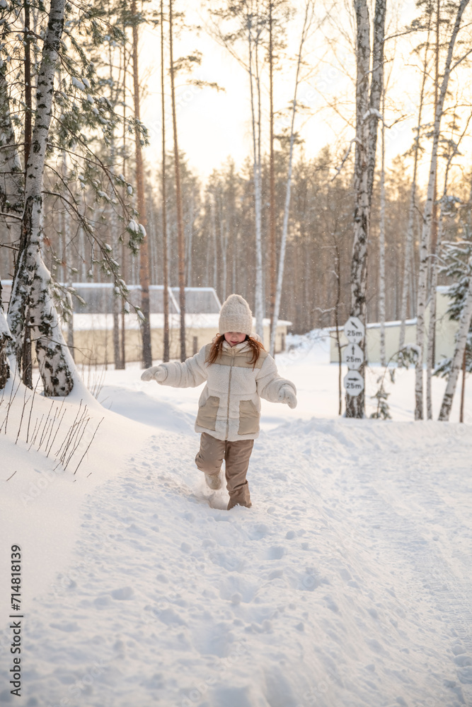 Cute little girl in winter walks in winter snow-covered forest. Winter Activities, Pastime, Walk