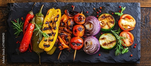 Assorted grilled veggies, displayed on a stone plate from above. Rustic look. © 2rogan